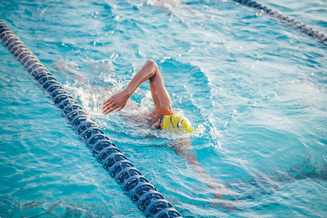Person swimming front crawl in a pool