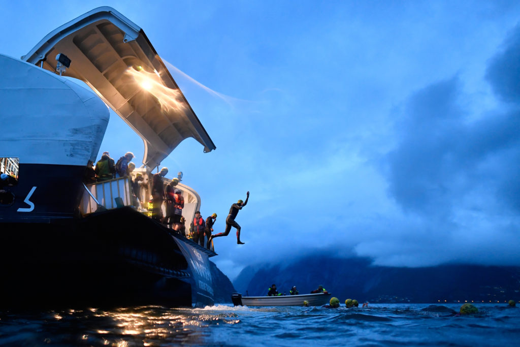 Triathletes jumping from the back of the ferry at Norseman