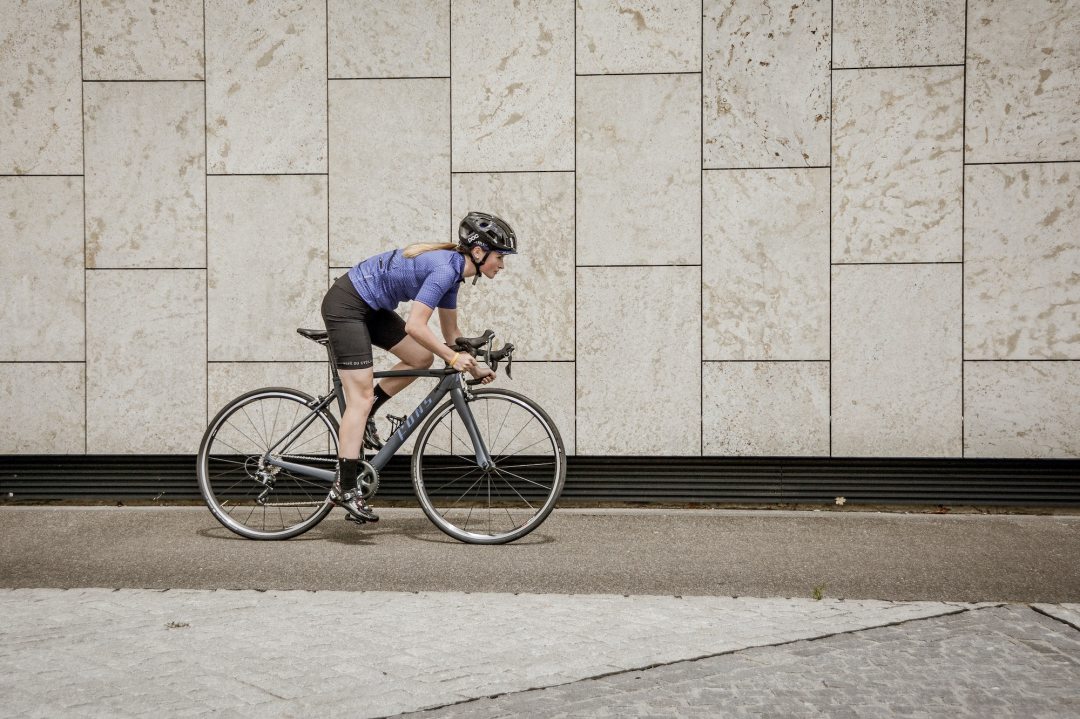 Woman cycling while using a bike phone mount