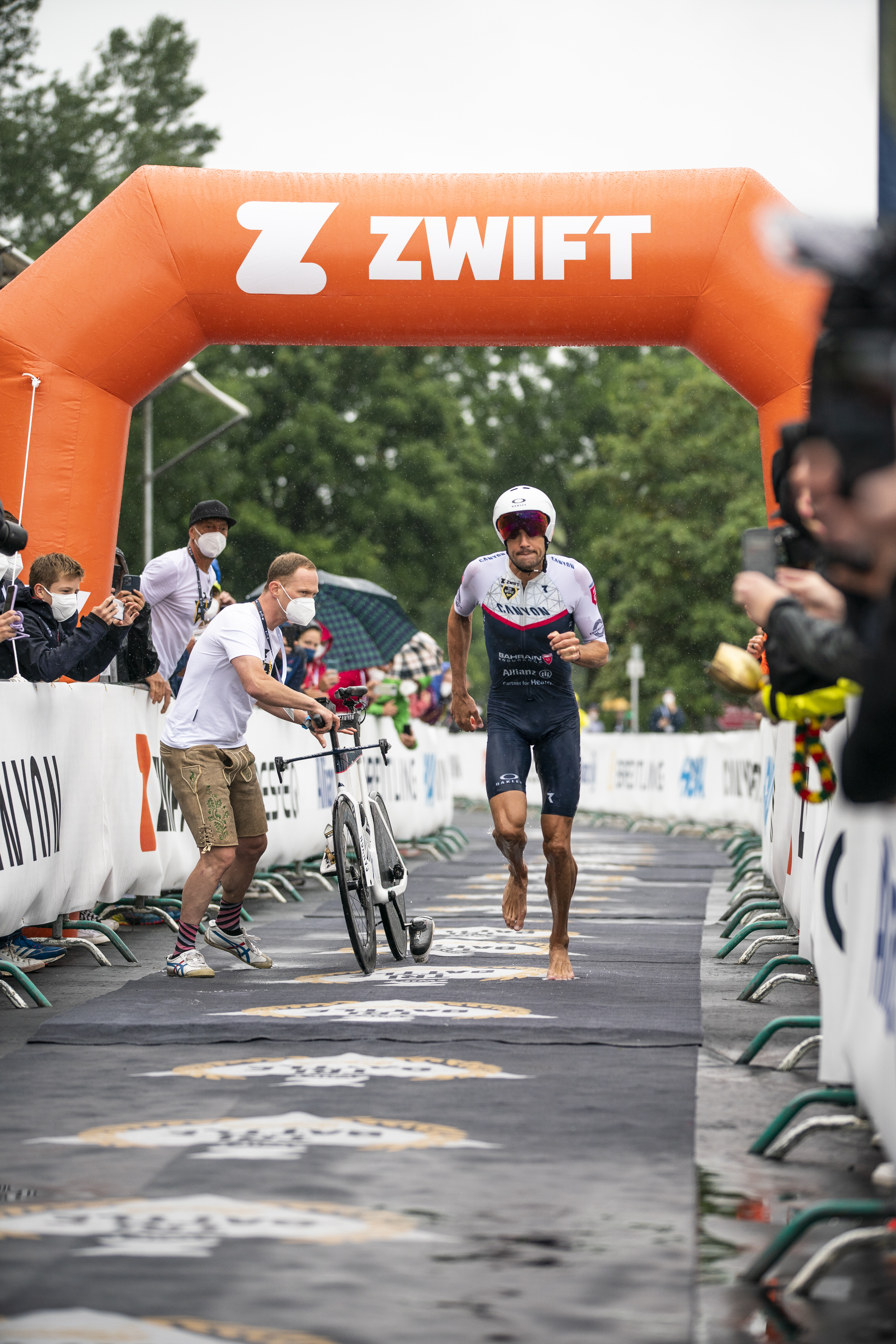 Jumping off the bike, Jan loosens the muscles ready to start the final marathon.