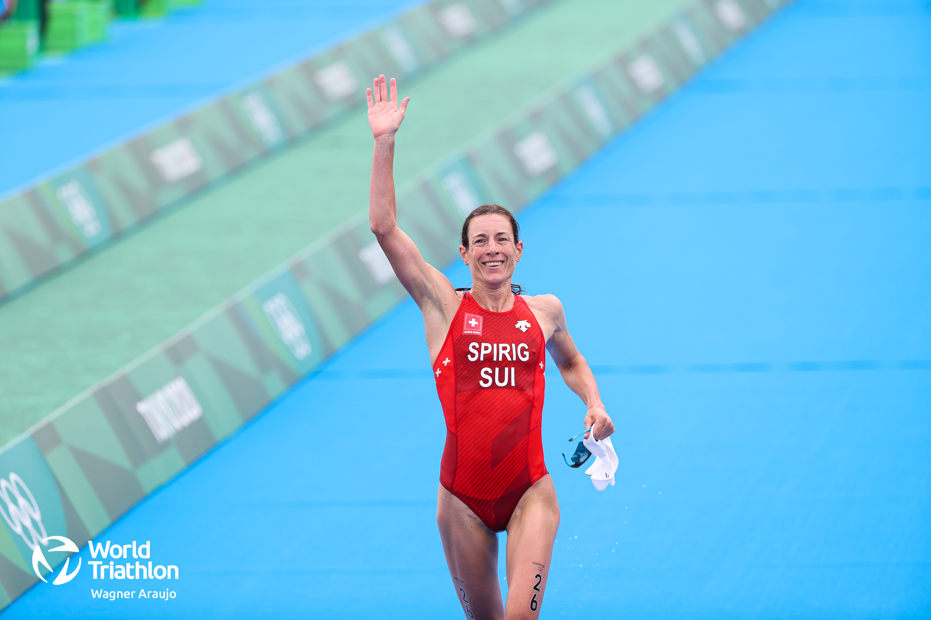 As the rain hammers down, Switzerland's Spirig finishes in sixth with possibly the most impressive performance of the race, having made immense ground on the bike and run. 