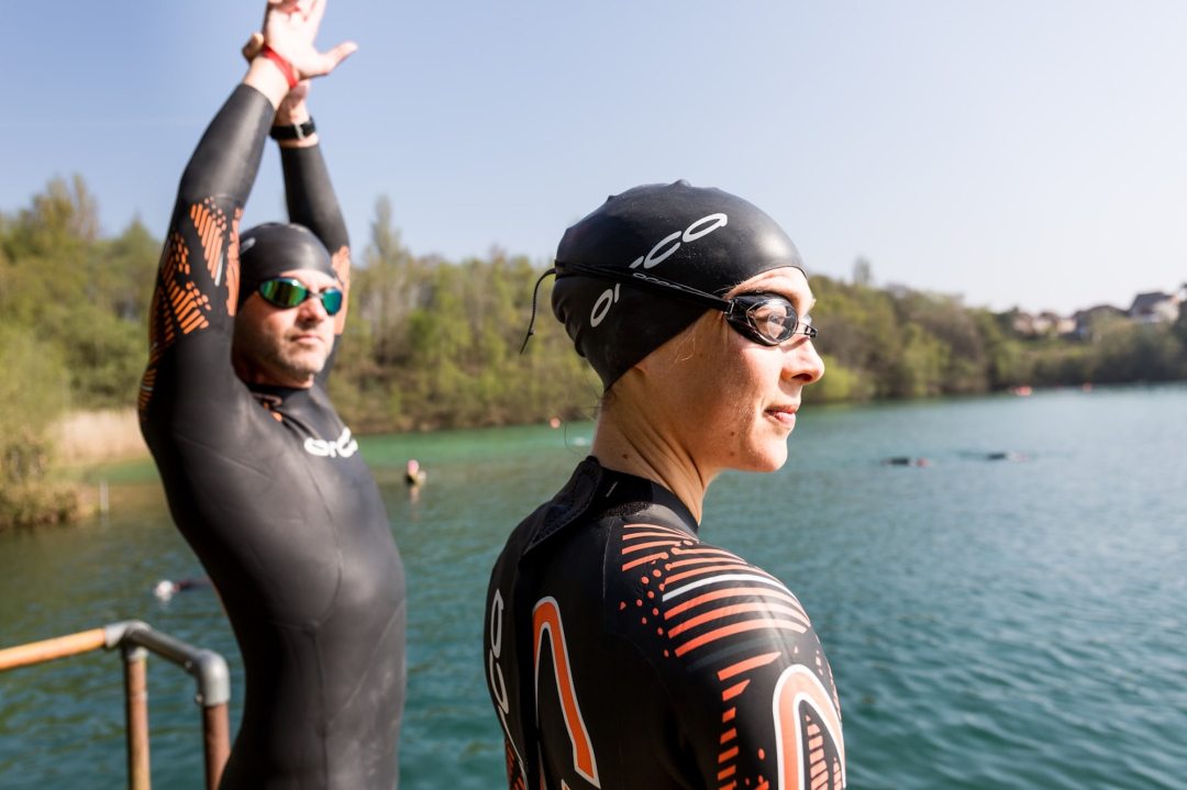 Swimmers in water by lake