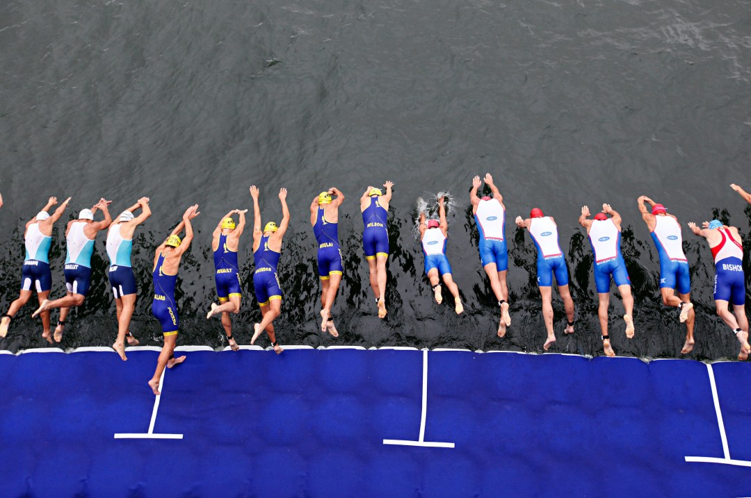 Triathletes diving into the swim at Paris Triathlon