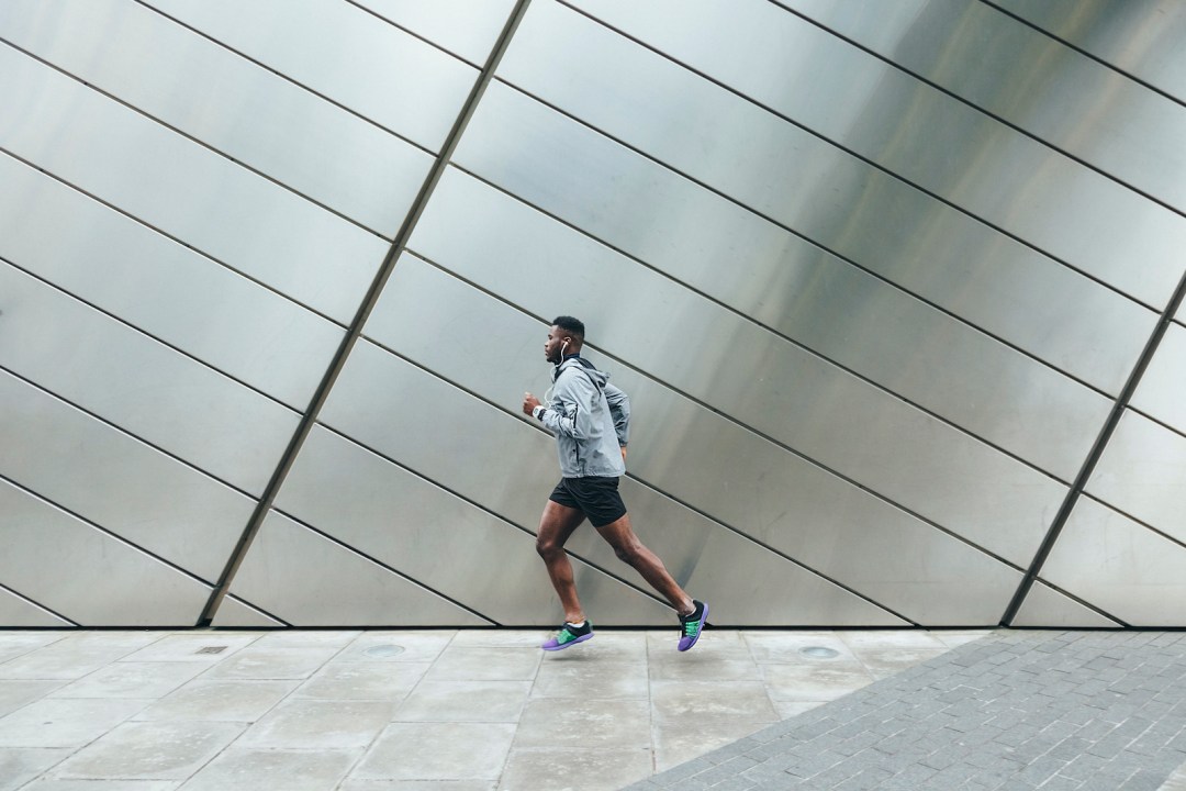 Man running while using running earphones