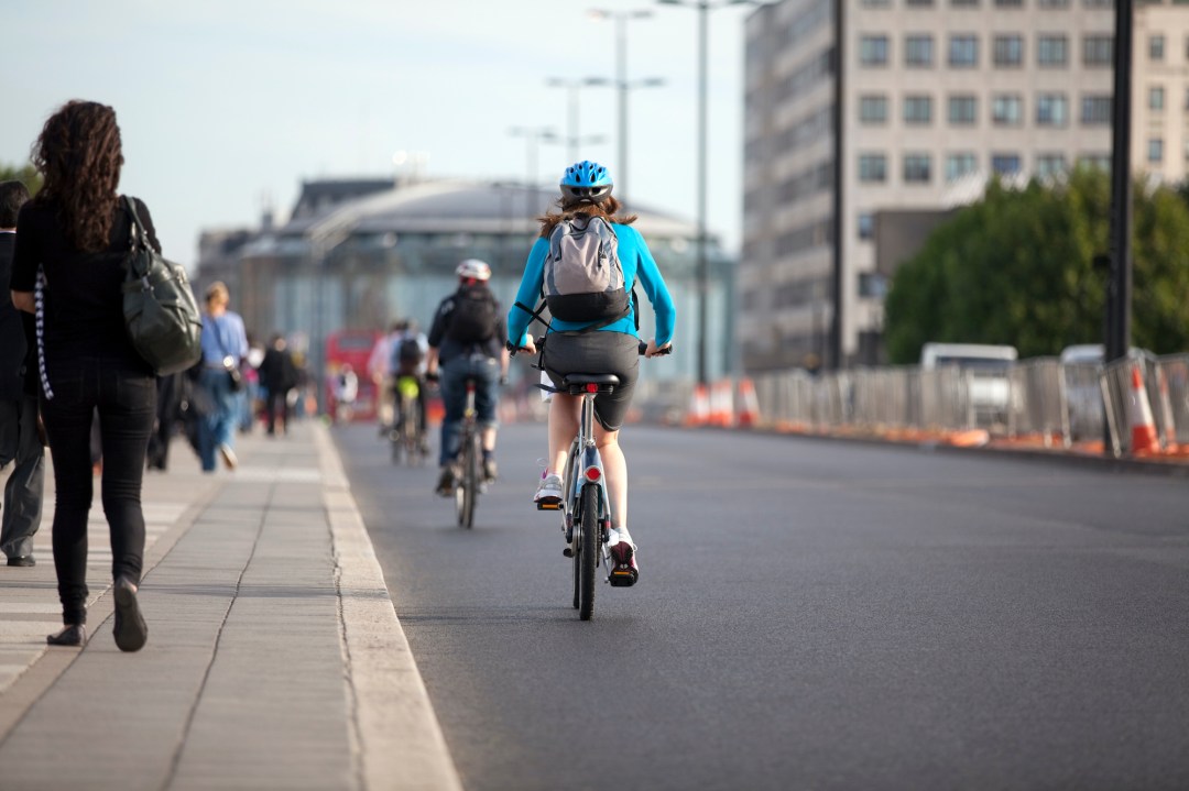 Woman cycling on road in London