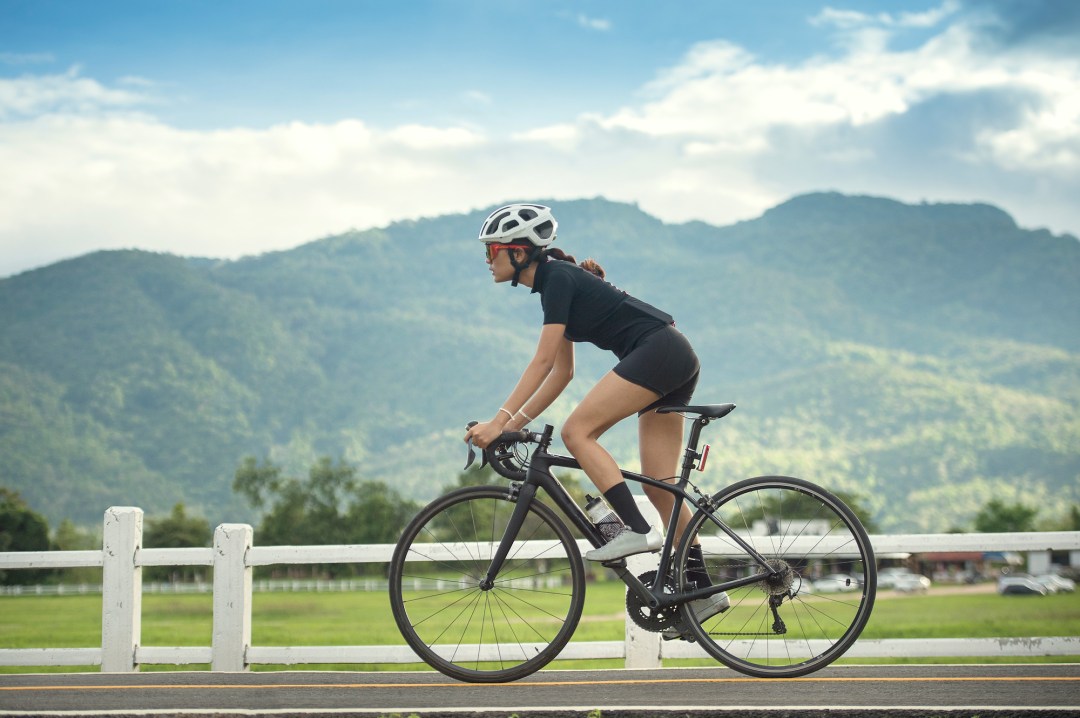 Woman stood up while riding a road bike