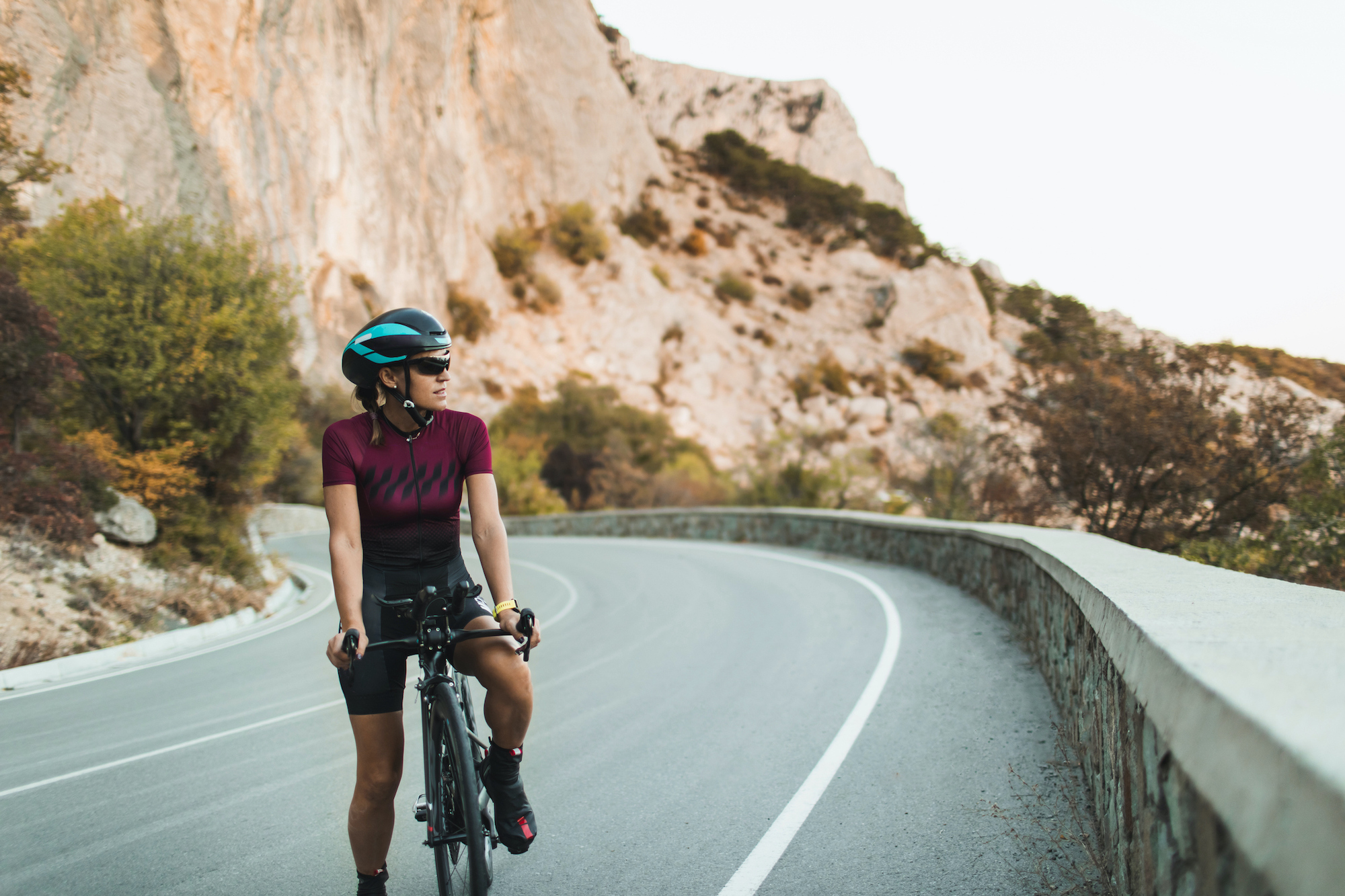 Woman stood over a triathlon bike