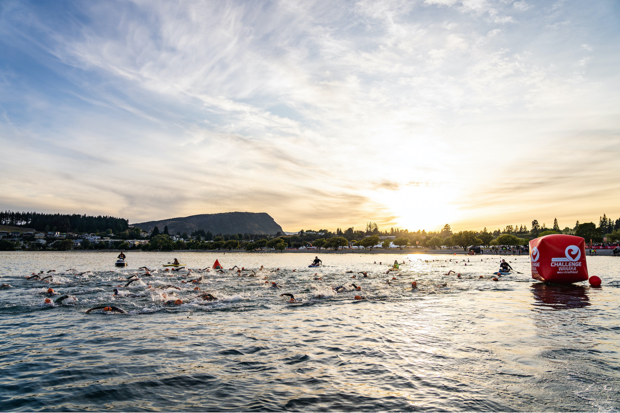 Triathletes swim as part of the Challenge Wanaka triathlon in New Zealand