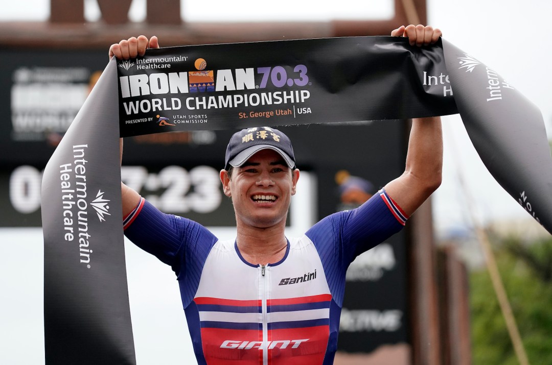 Gustav Iden crosses the finish line and wins the Ironman 70.3 World Championship in 2021