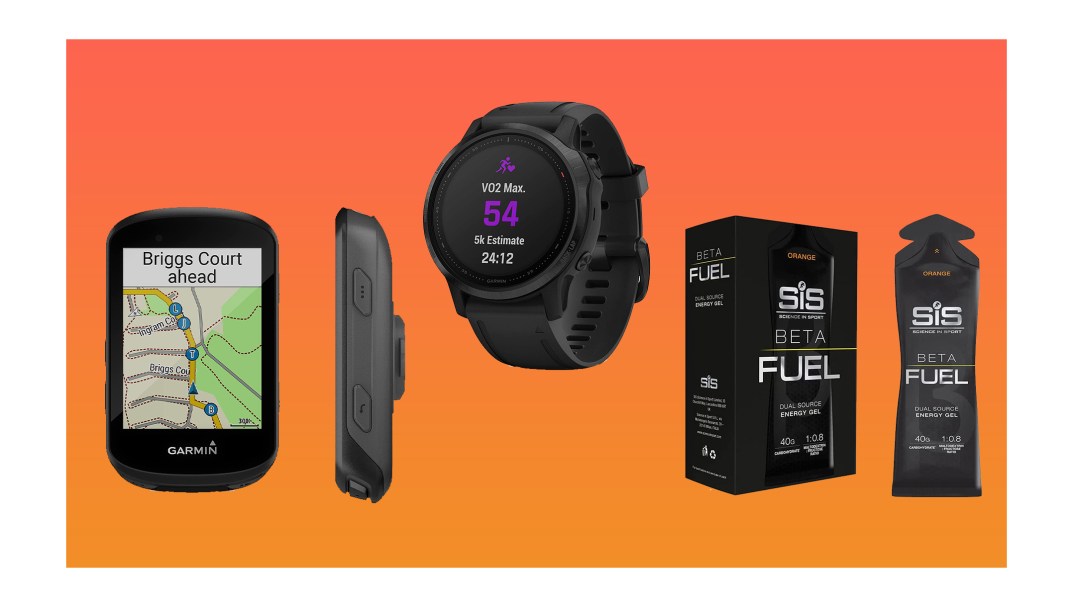 Bike computer, Garmin watch and SIS energy pouches on an orange background