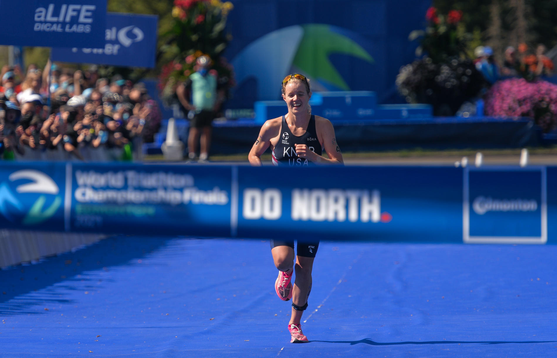 Taylor Knibb runs to the finish line at the World Triathlon Championship Finals in Edmonton