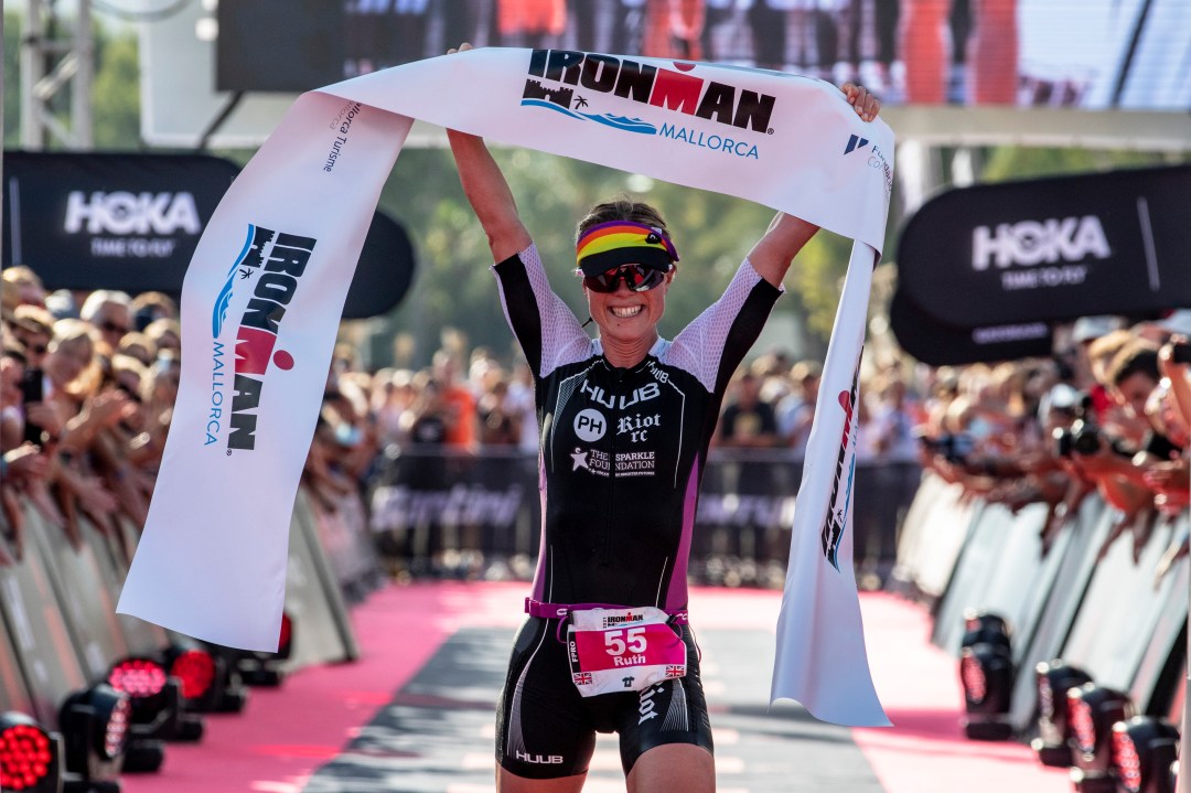 Ruth Astle of Great Britain celebrates winning the women's Ironman Mallorca on October 16, 2021 in Mallorca, Spain.