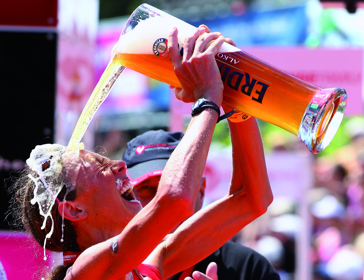 ROTH, GERMANY - JULY 10: Chrissie Wellington of England enjoys a glas of beer after winning the Challenge Roth Triathlon with a new long distance world record on July 10, 2011 in Roth, Germany. (Photo by Alexander Hassenstein/Getty Images for Challenge Roth) *** Local Caption *** Chrissie Wellington