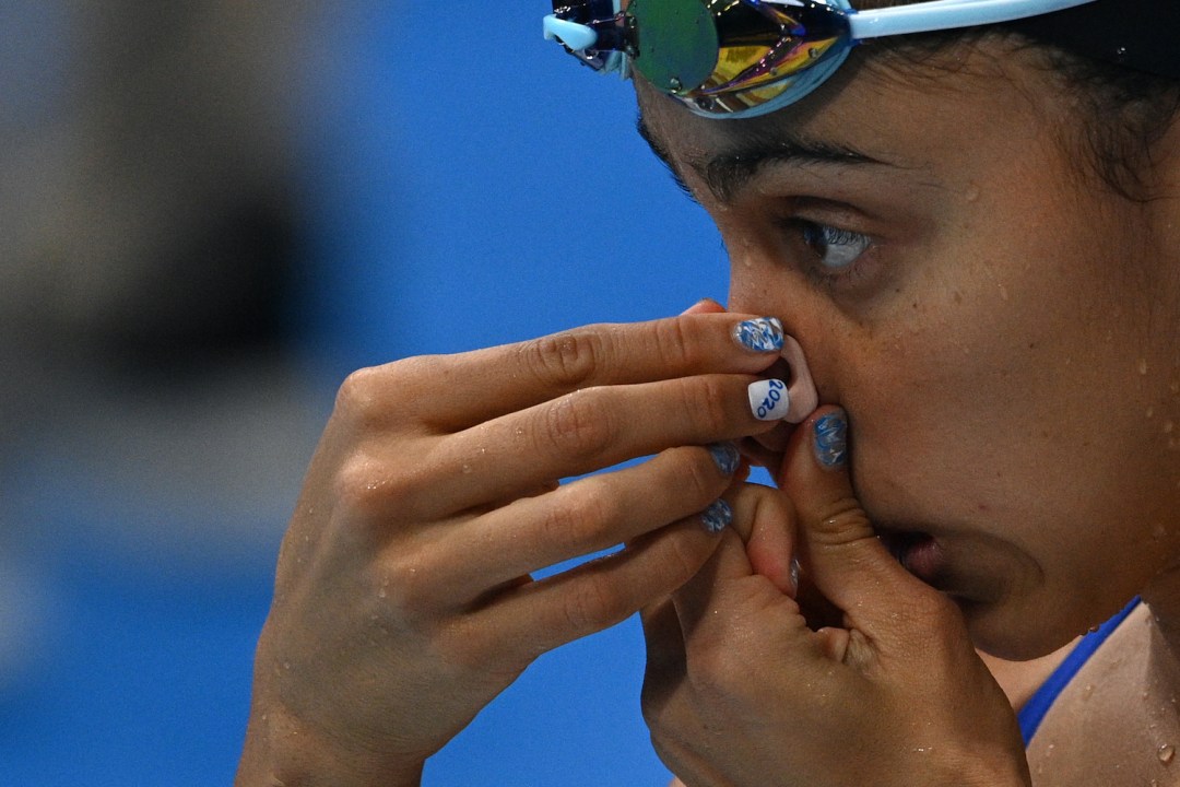 Woman using nose clips for swimming