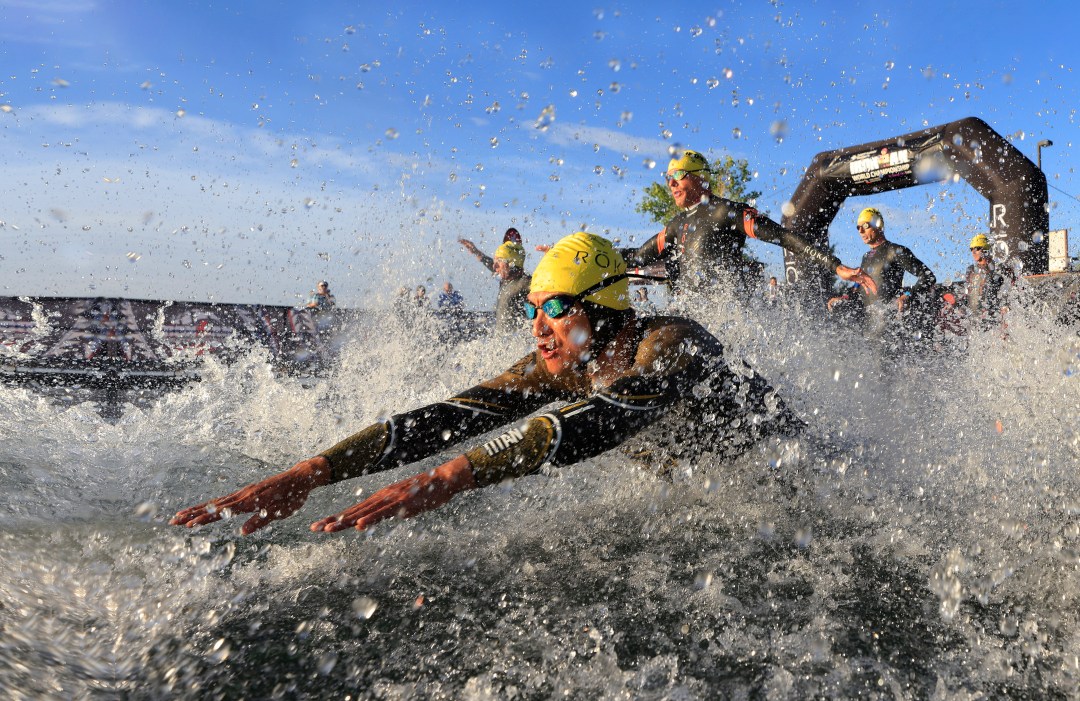 swimmer diving in at the start of a triathlon