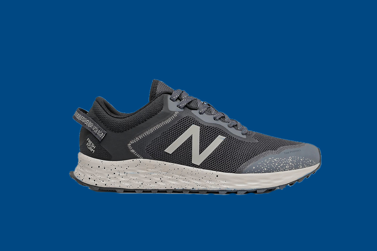 New Balance FreshFoam Arishi Trail run shoes on a blue background