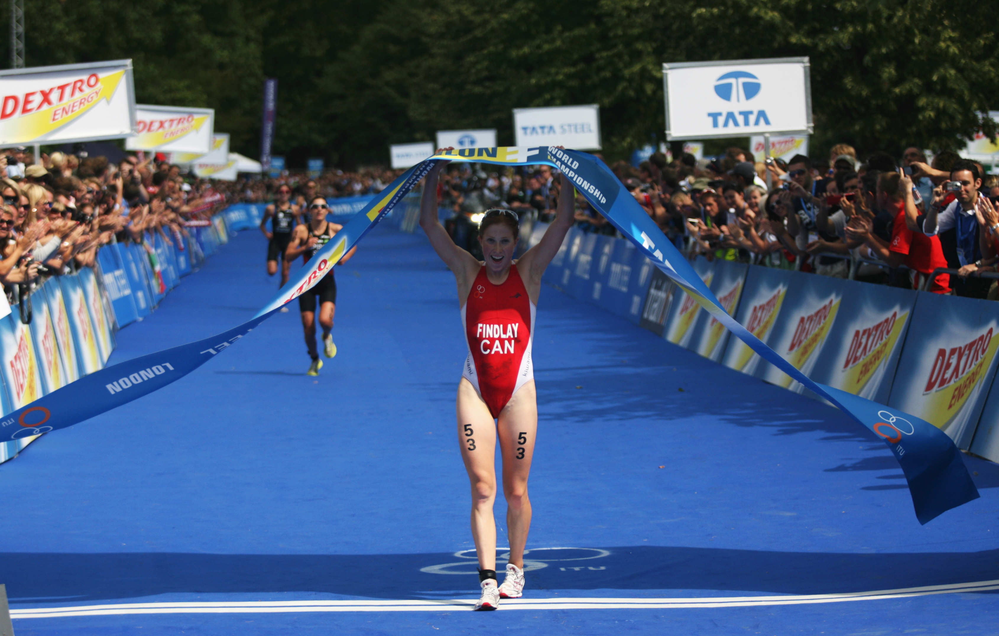 LONDON - JULY 24: Paula Findlay of Canada (53) celebrates winning the Dextro Energy Triathlon Women's Race in Hyde Park on July 24, 2010 in London, England. (Photo by Mark Wieland/Getty Images)