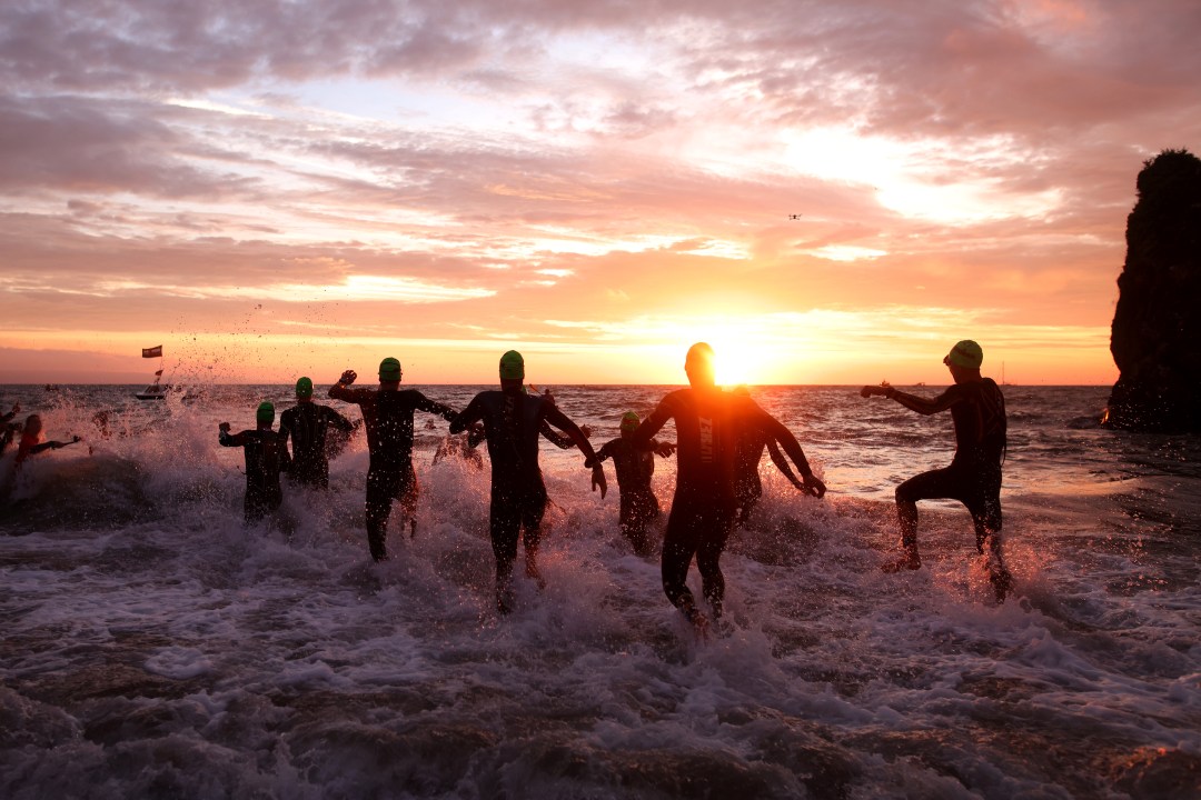 The professional men enter the water as they begin the race by starting with the swim leg during the IRONMAN Wales on September 11, 2022 in Tenby, Wales