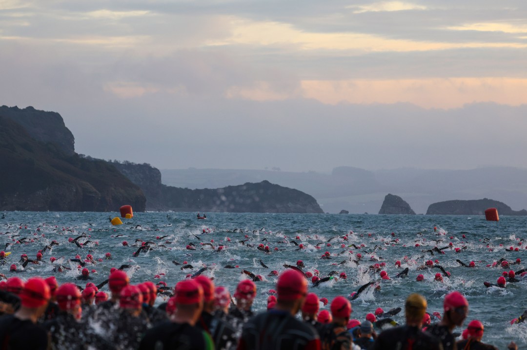 Athletes compete in the swim section of Ironman Wales 2022.