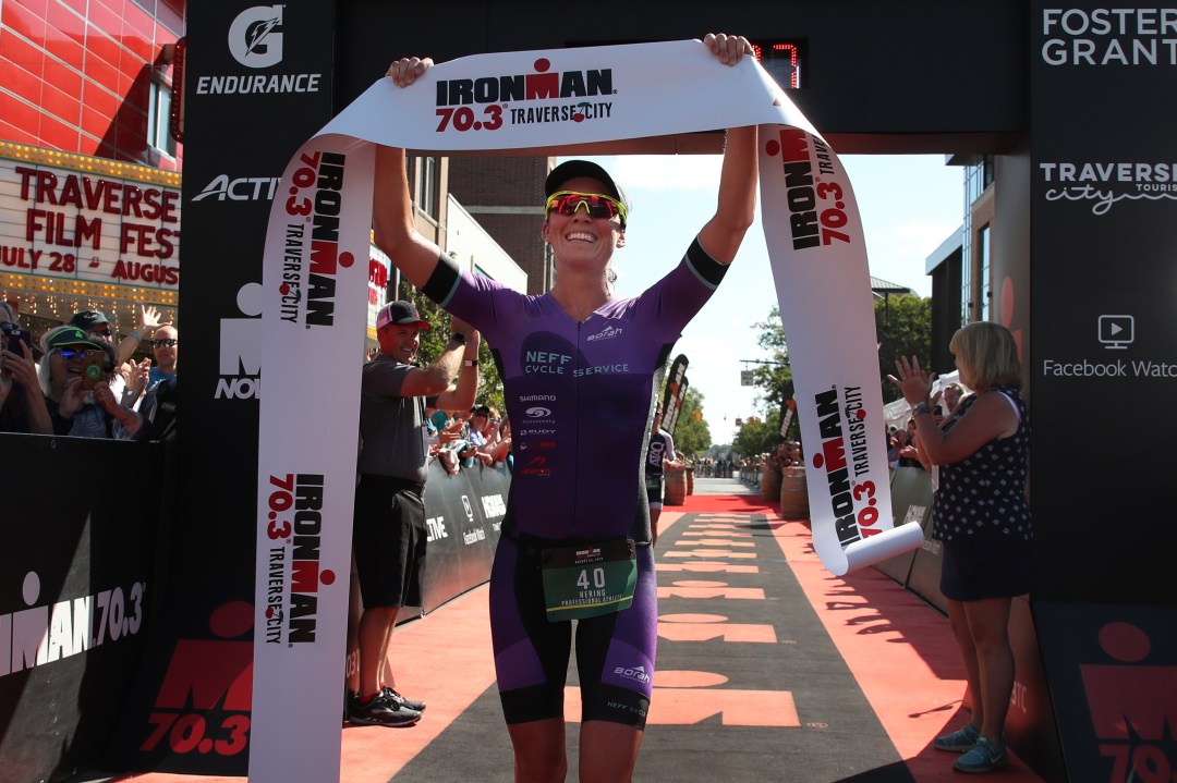 Jackie Hering celebrates her first place finish at Ironman 70.3 Traverse City on August 25, 2019 in Traverse City, Michigan.
