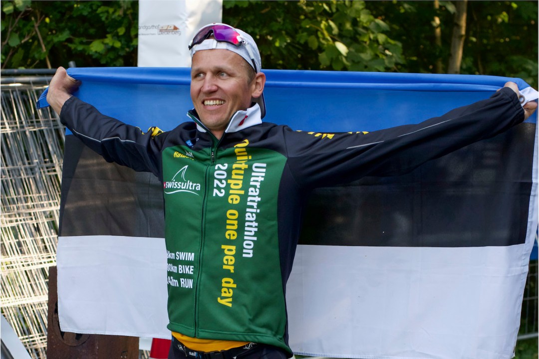 Rait Ratasepp celebrates after setting a new triathlon record