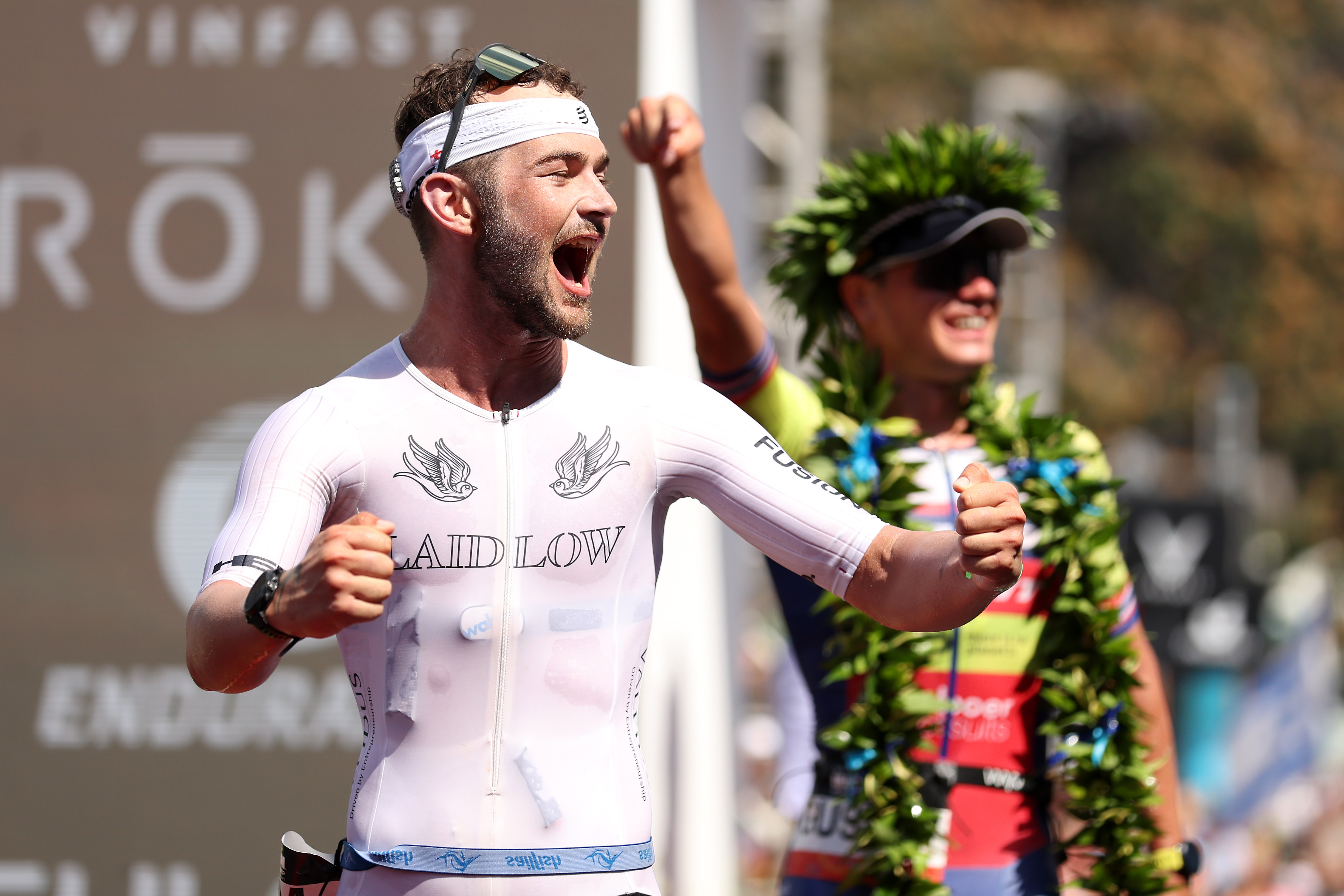 Laidlow celebrates his second place finish in Kona last year, with 2022 Ironman world champ Gustav Iden in the background (Credit: Ezra Shaw/Getty Images for Ironman)