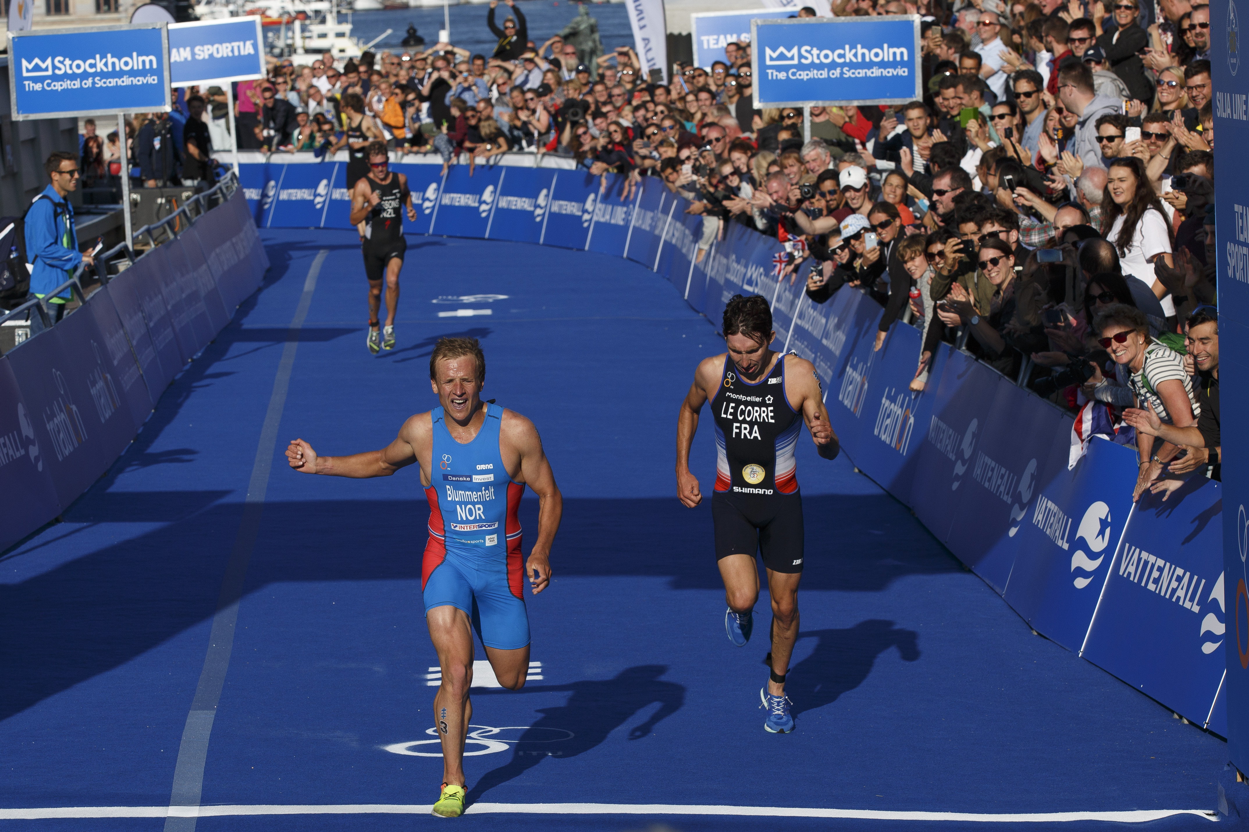 STOCKHOLM, SWEDEN - AUGUST 26: Athletes Kristian Blummenfelt from Norway (L) second and Pierre Le Corre from France (R) third cross the finish line during the men's Elite race of Vattenfall World Triathlon Stockholm on August 26, 2017 in Stockholm, Sweden. (Photo by Pablo Blazquez Dominguez/Getty Images for WTS)