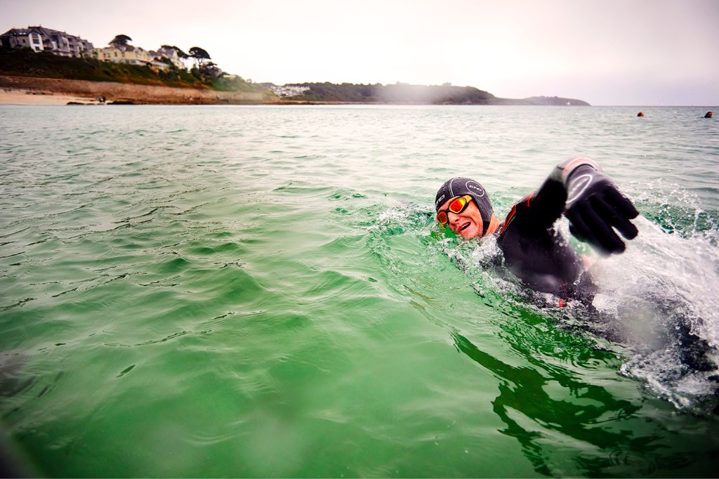 Person swimming in cold water