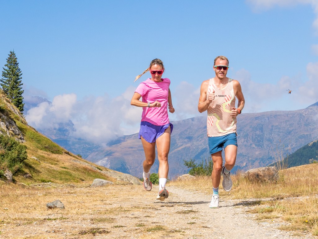 Two athletes using their triathlon watch while training