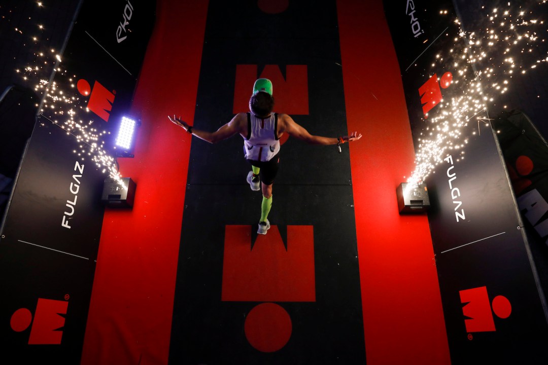 An athlete celebrates crossing the finish line during IRONMAN Finland on August 13, 2022 in Kuopio, Finland