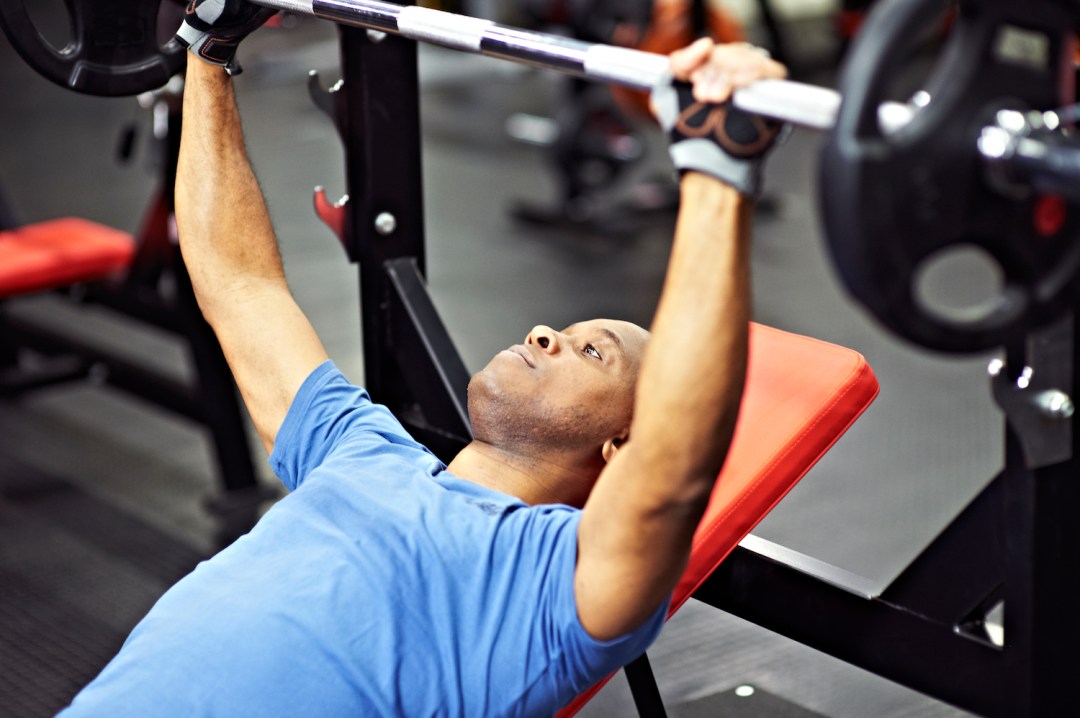 Man using weights with gloves