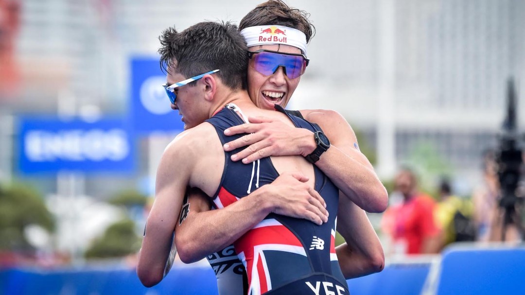 Alex Yee and Hayden Wilde embrace at the finish line of the 2022 Yokohama WTCS race