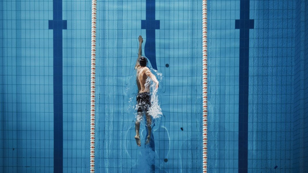 Aerial view of male swimmer training in pool