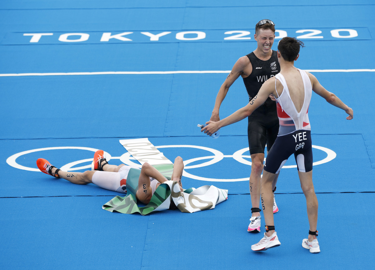Kristian Blummenfelt (gold), Hayden Wilde (bronze) and Alex Yee (silver) celebrate at the finish line after finishing the Tokyo 2020 Olympic Games men's triathlon