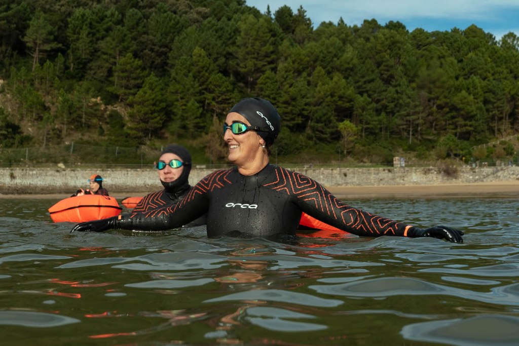 Woman swimming in Orca wetsuit