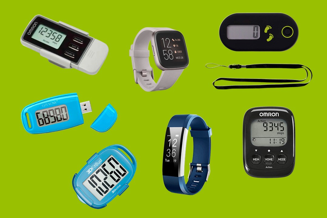 A selection of pedometers on a green background