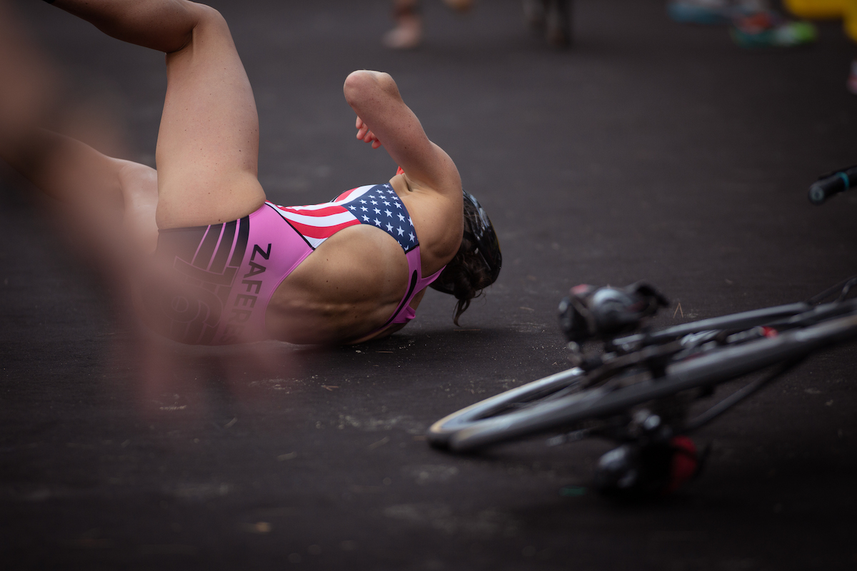 The USA'S Katie Zaferes lies on the floor on her side after crashing during the Sprint Enduro Stage Two race at the 2018 Mallorca Super League Triathlon.