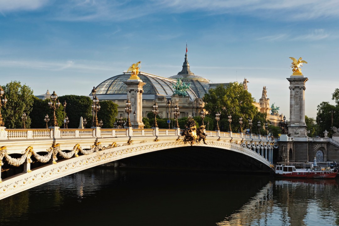 View of the Le Grand Palais, Paris, with the Pont Alexandre-III over the Seine river in the foreground