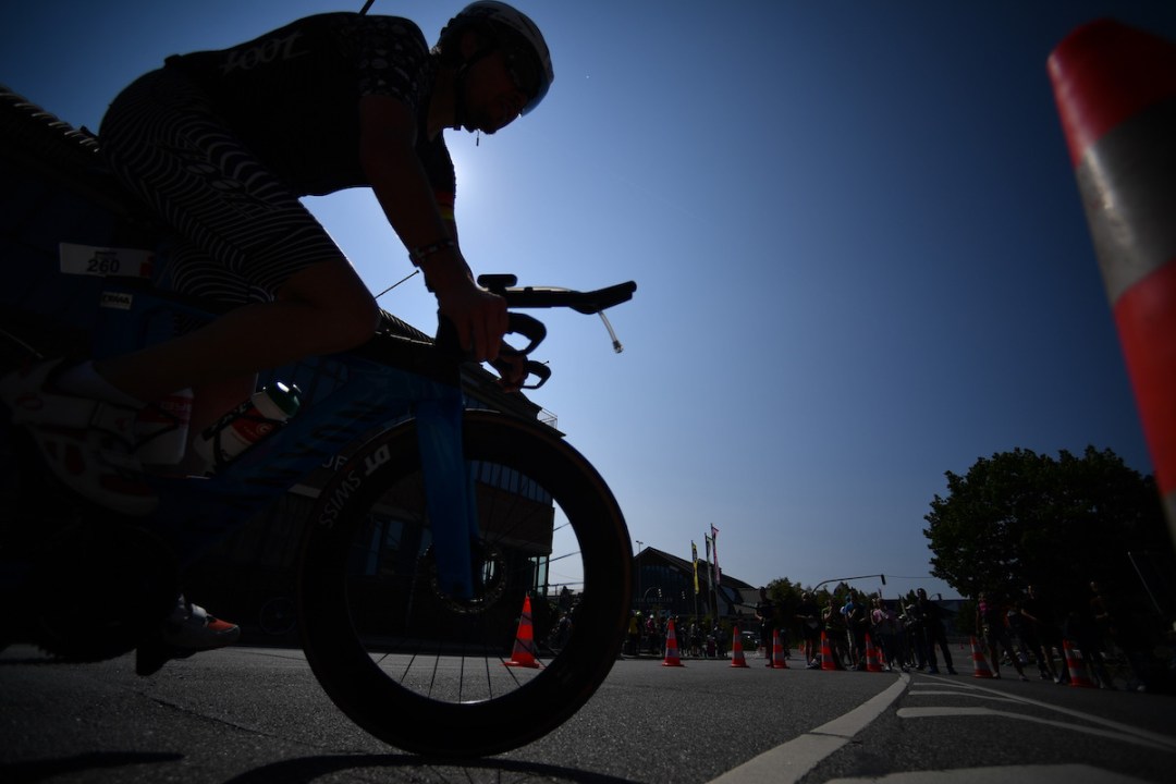 A close-up of a cyclist in silhouette on the Ironman European Championship Hamburg bike course