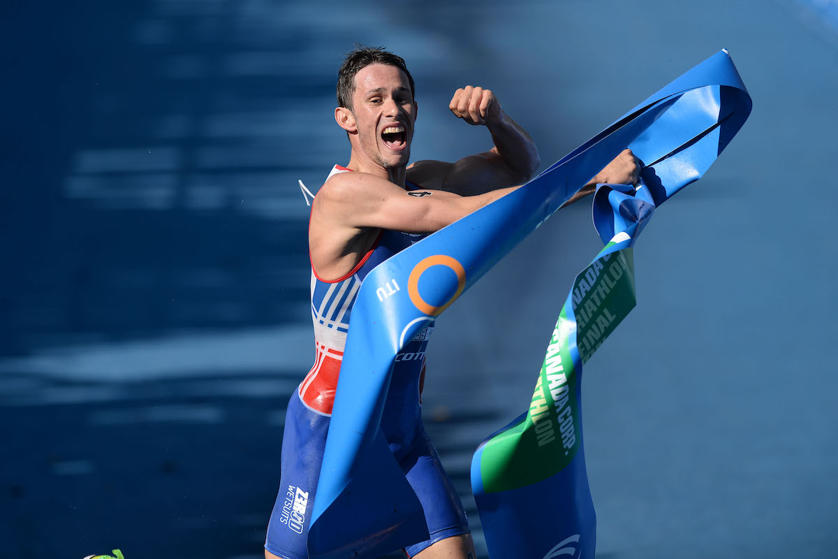 Frenchman Dorian Coninx grabs the finisher's tape and raises his left fist in celebration having just won the 2014 World U23 Champs in Edmonton, Canada