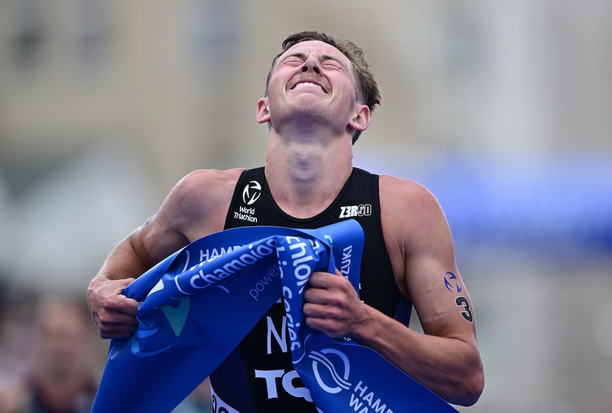 New Zealand triathlete Hayden Wilde crosses the line as the 2023 World Super Sprint Champion and winner of the 2023 WTCS Hamburg round