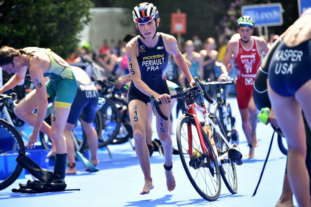 French triathlete Léonie Périault wheels her bike out of T1 at WTCS Leeds 2018