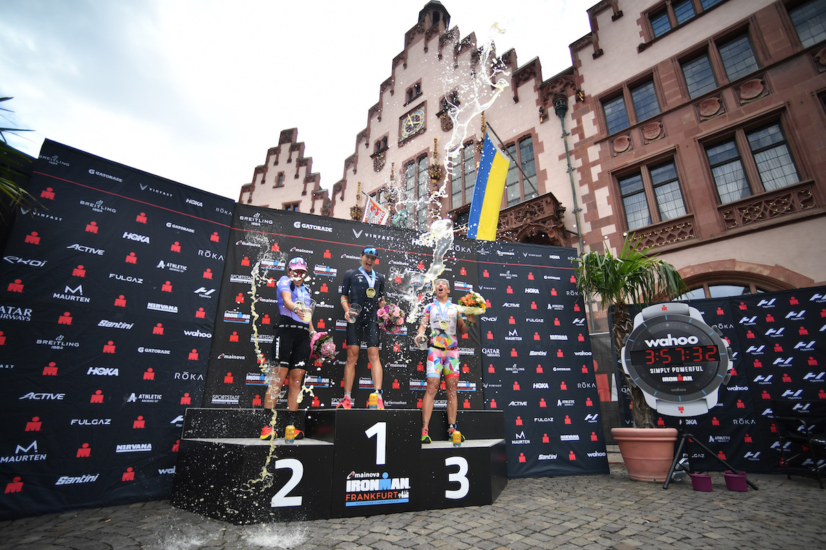 L-R: Skye Moench (2nd), Sarah True (1st) and Agnieszka Jerzyk  (3rd) celebrate on the podium at the 2023 Ironman European Championship in Frankfurt, Germany