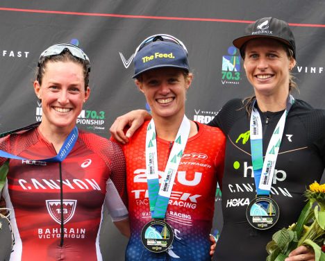 L-R: Kat Mathews (silver), Taylor Knibb (gold) and Imogen Simmonds (bronze) pose on the 2023 Ironman 70.3 World Championship podium, in Lahti, Finland.