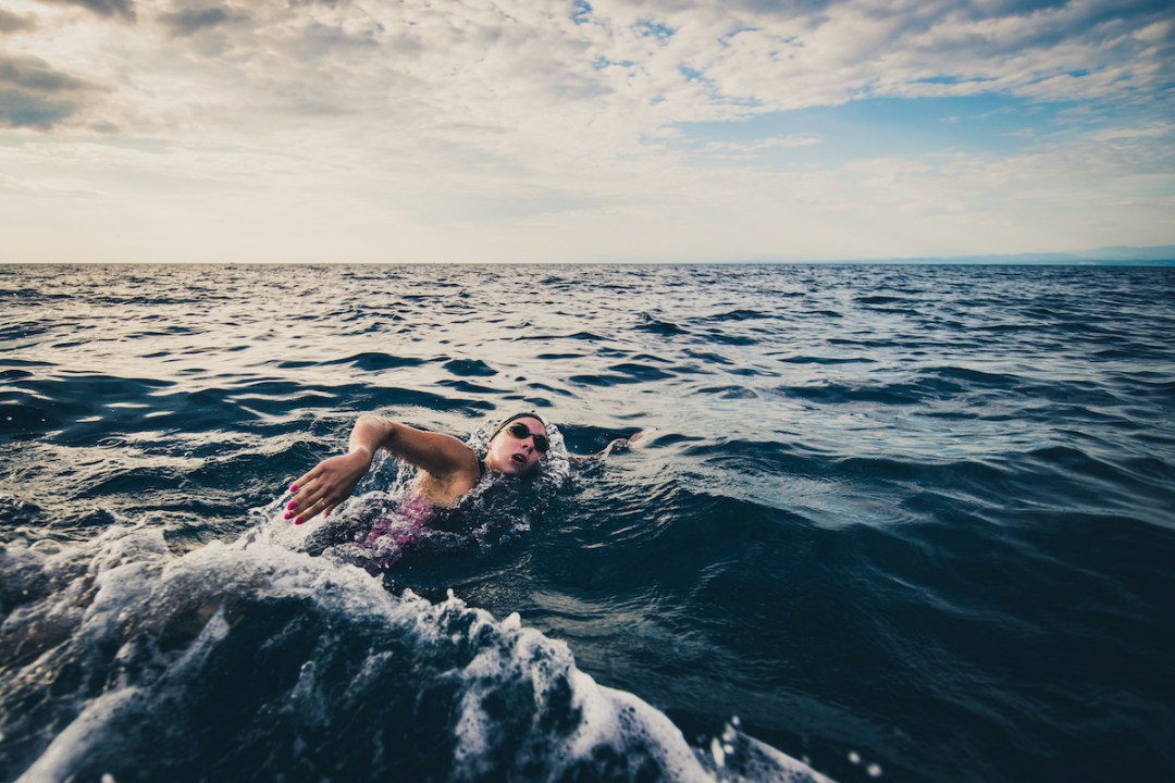 Female open-water swimmer swimming in sea