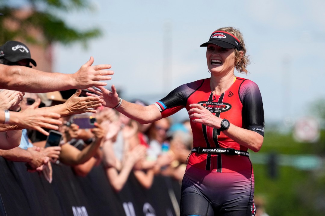 Melanie McQuaid of Canada celebrates as she approaches the finish line in third place at Ironman Coeur d'Alene on June 25, 2023.