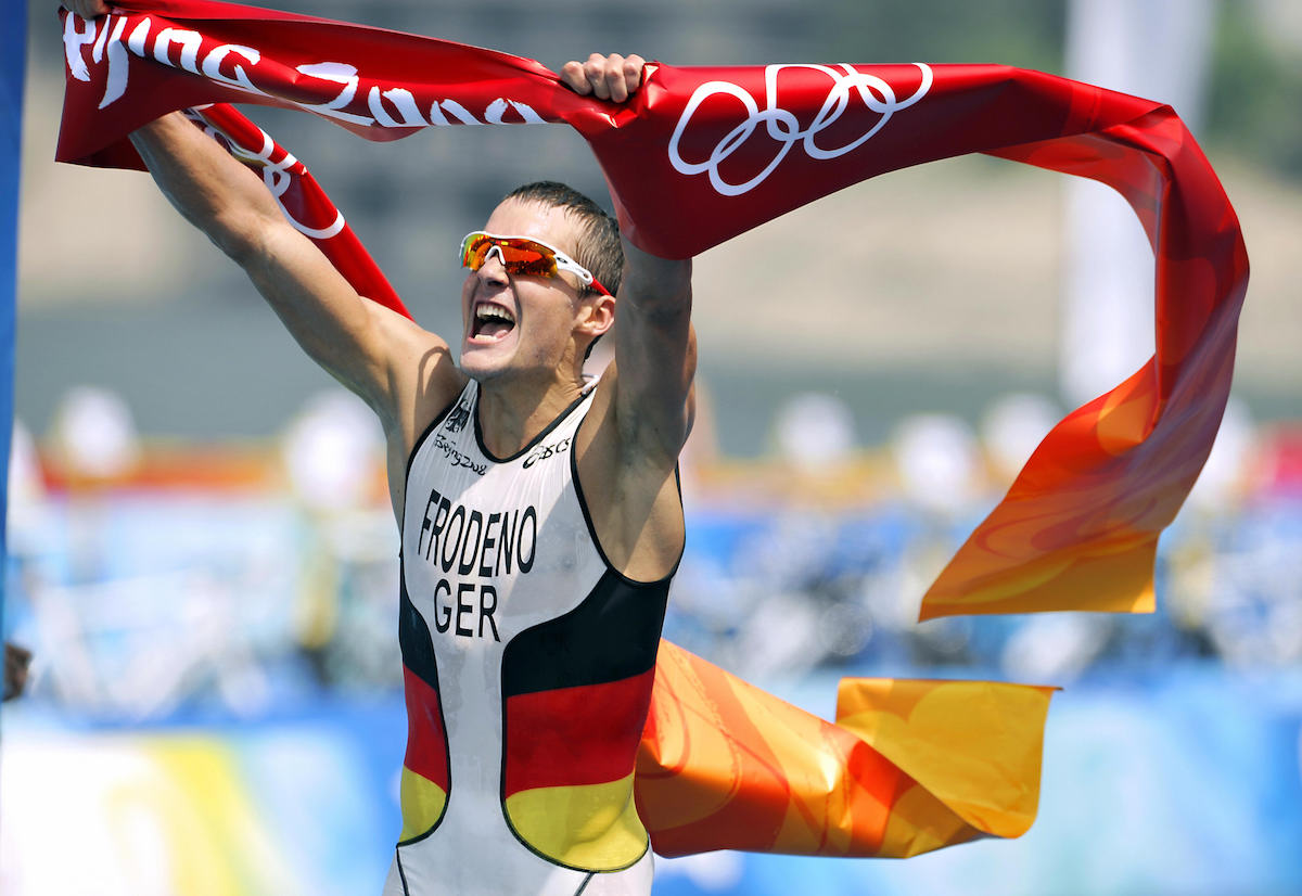 Germany's Jan Frodeno celebrates as he crosses the finish line of the men's triathlon competition at the Beijing 2008 Olympic Games on August 19, 2008.  