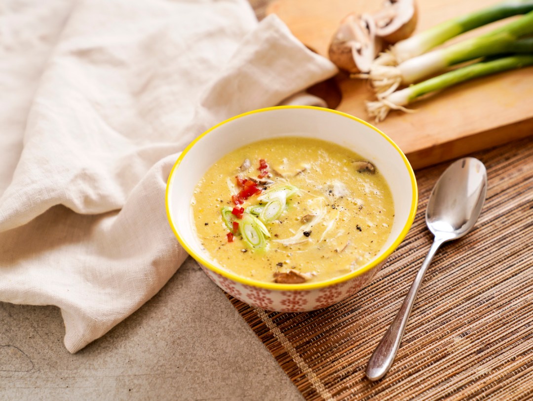 Close up of a bowl of sweetcorn soup