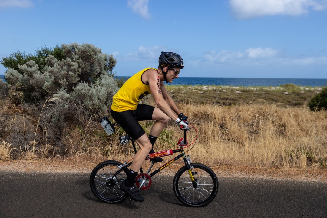 Dave Lowry racing on a BMX bike at Ironman Western Australia, 2023