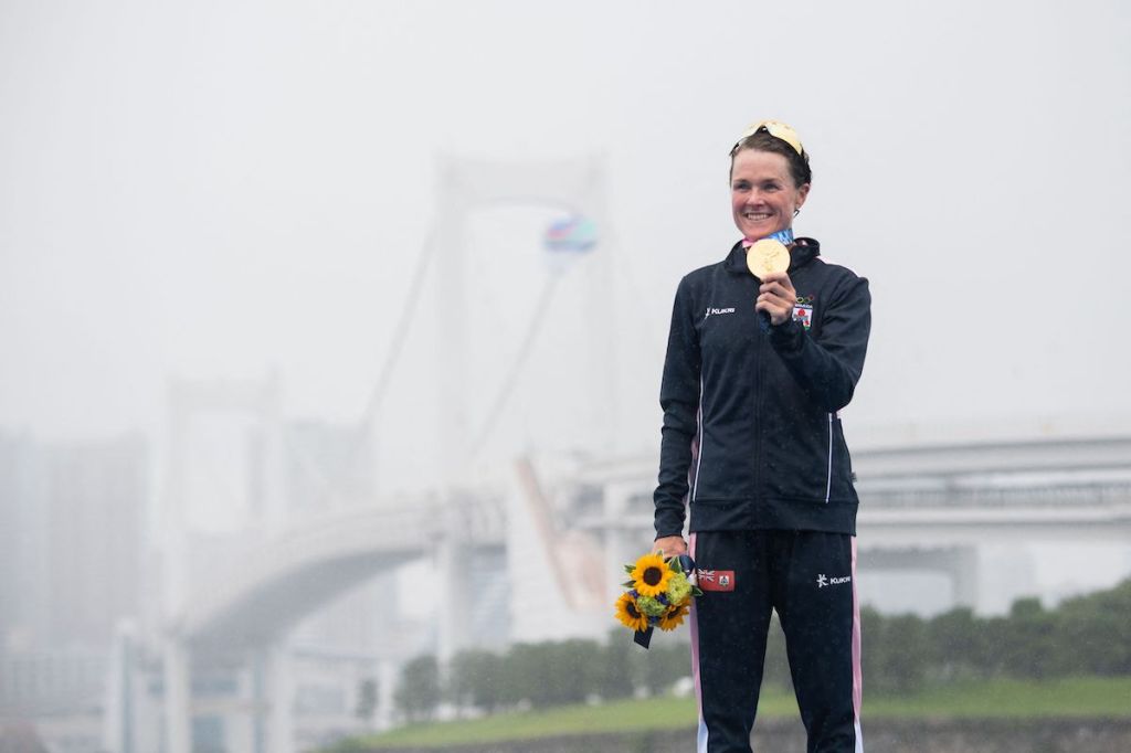Flora Duffy poses with her gold medal on the podium after winning the Tokyo 2020 Olympic Games women's triathlon race